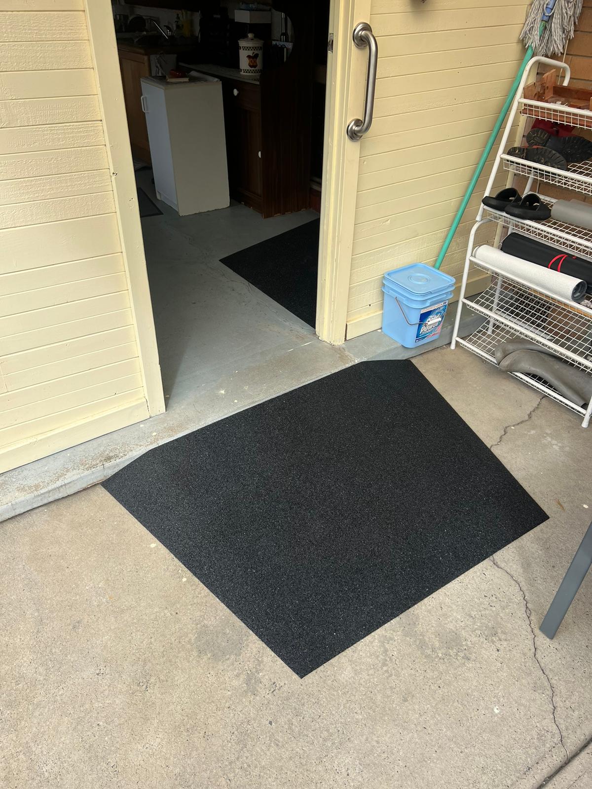 Black rubber ramp installed at door
