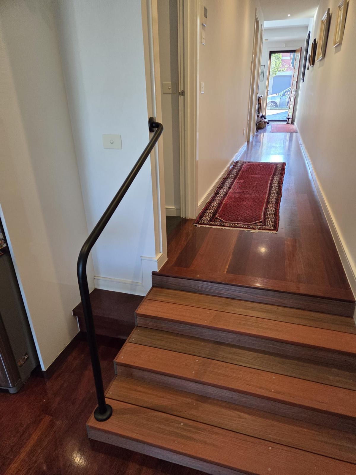 Indoor handrail on timber steps